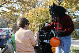 Volunteers handing out candy at Halloween hike